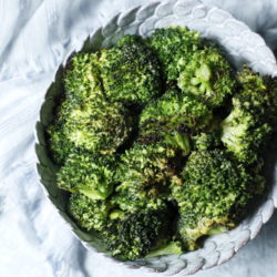 Sriracha Roasted Broccoli in a white pottery bowl shot from above