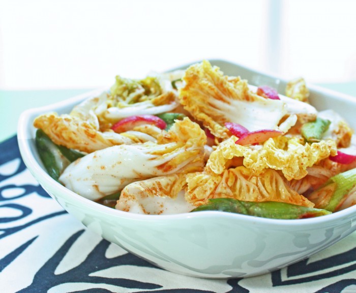 keto kimchi salad in a white plate on a blue and white asian themed napkin