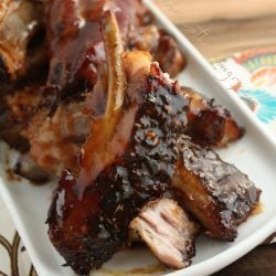 low carb jerk bbq ribs cut into sections and arranged on a white platter