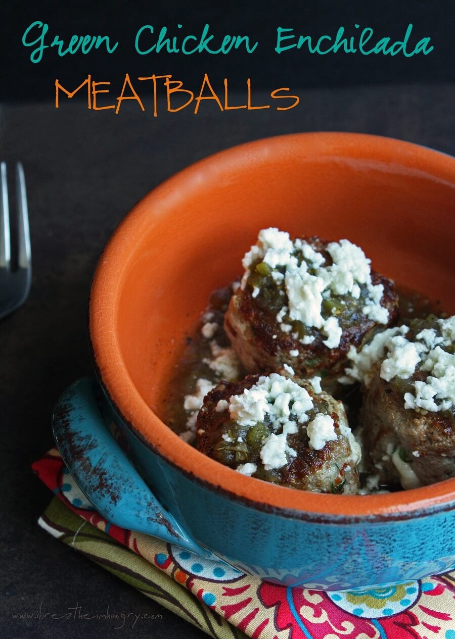 green chicken enchilada meatballs in an orange pottery dish sprinkled with queso fresco cheese.