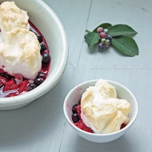 white bowl with a serving of keto meringues with berries