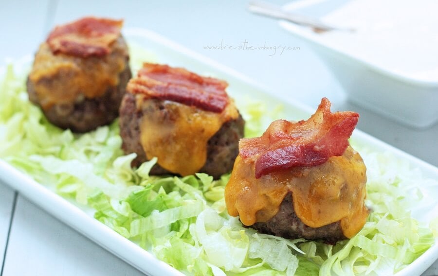 3 bacon cheeseburger meatballs on a platter.