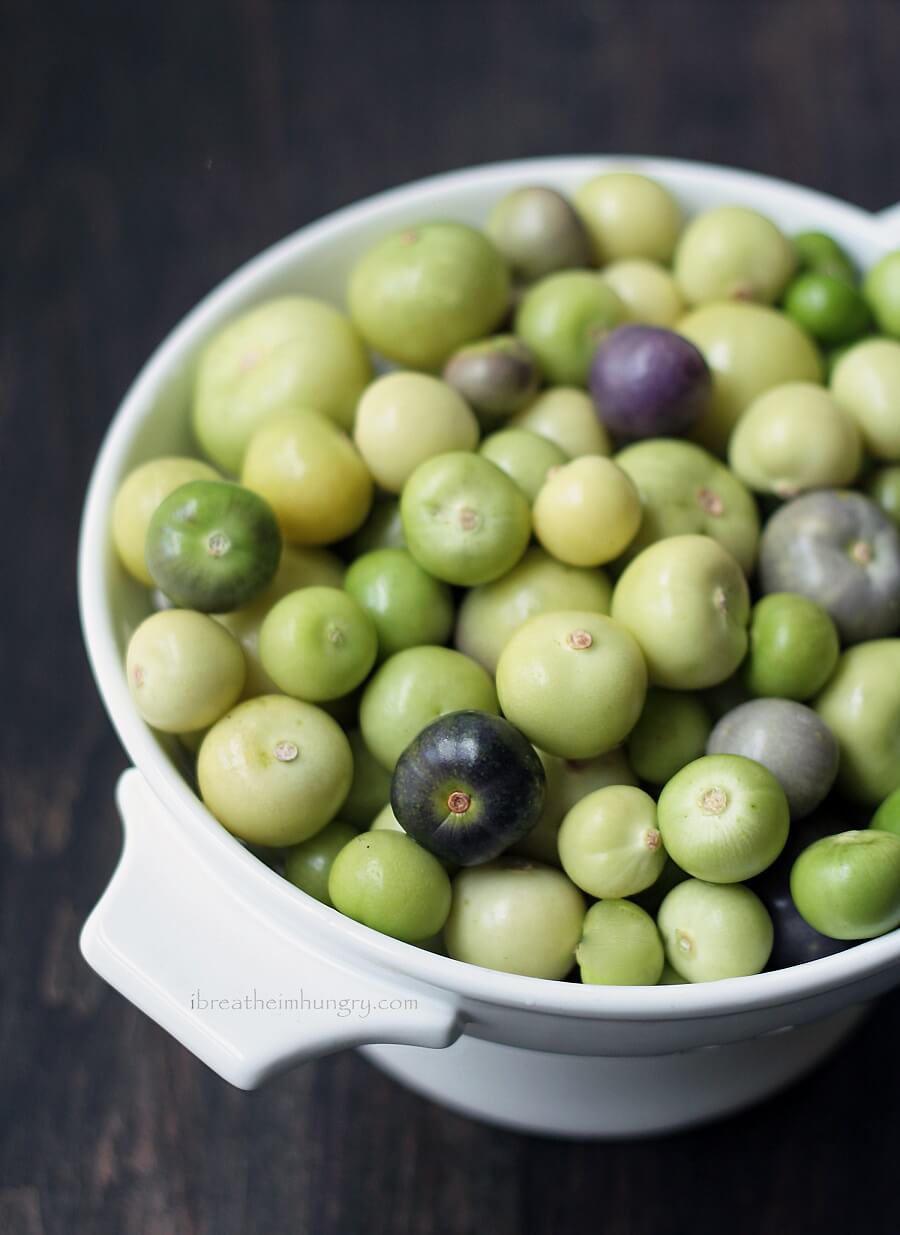 raw tomatillos in a white colander