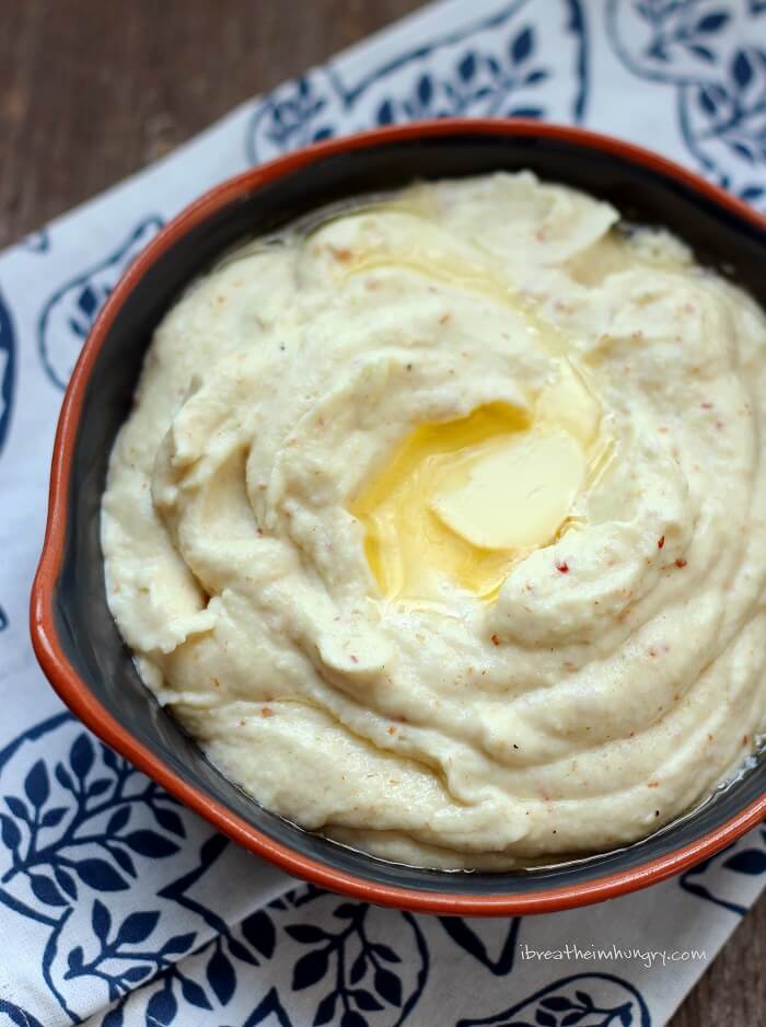 Top view of Bacon and Smoked Gouda Cauliflower puree with a pat of butter melting on the top