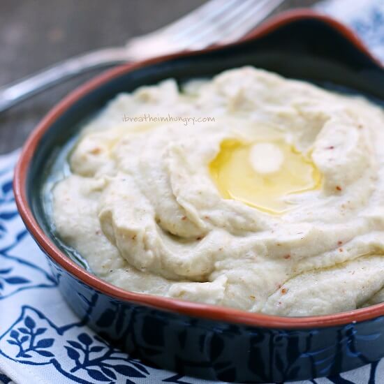 keto bacon & smoked gouda cauliflower puree in a blue pottery bowl