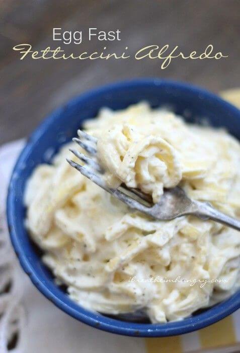 Fettuccini Alfredo showing a forkful on top and in a blue bowl