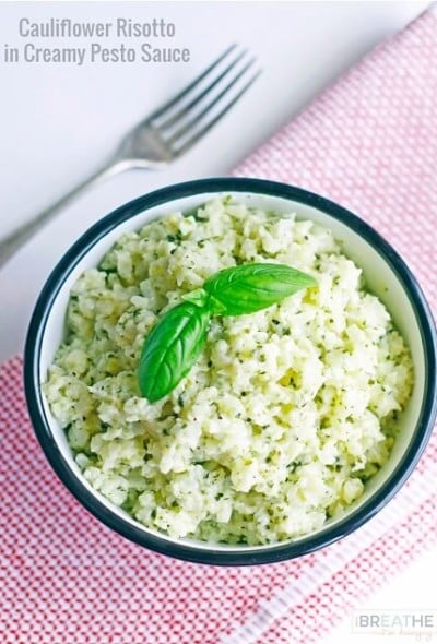 This versatile low carb side dish recipe perfectly mimics a classic risotto but is made with cauliflower in a cheesy pesto sauce. Keto and Atkins friendly.