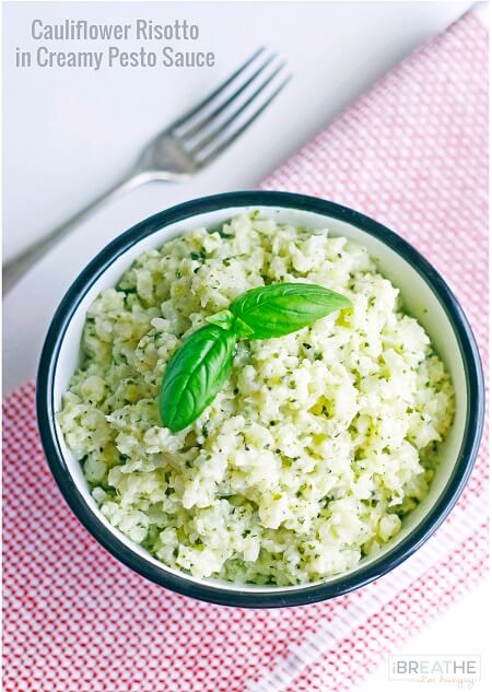 This versatile low carb side dish recipe perfectly mimics a classic risotto but is made with cauliflower in a cheesy pesto sauce. Keto and Atkins friendly.
