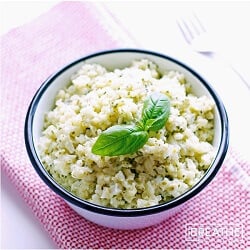 This versatile low carb side dish recipe perfectly mimics a classic risotto but is made with cauliflower in a cheesy pesto sauce. Keto and Atkins friendly.
