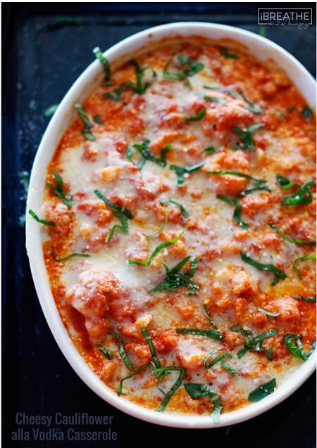 keto cauliflower alla vodka casserole on a dark background garnished with fresh basil