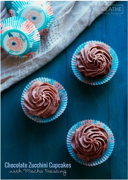 low carb Chocolate Zucchini Cupcakes with Mocha Frosting shot from above on a teal wooden board