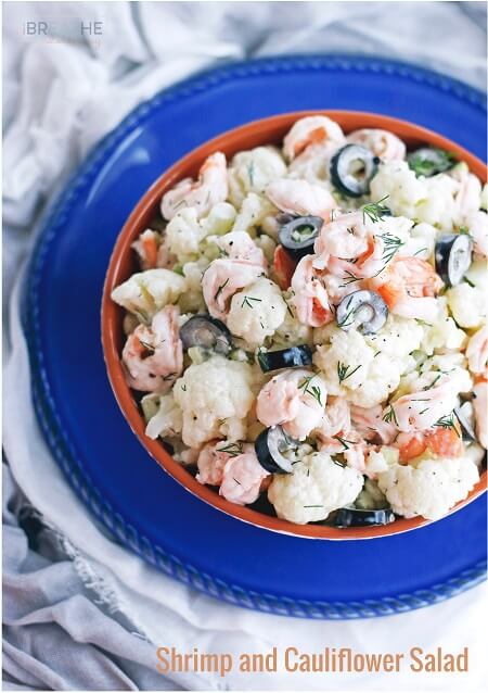 Keto Shrimp Salad in a terra cotta bowl on a blue plate.