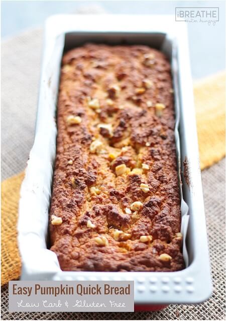 keto pumpkin bread in a loaf pan garnished with pecans