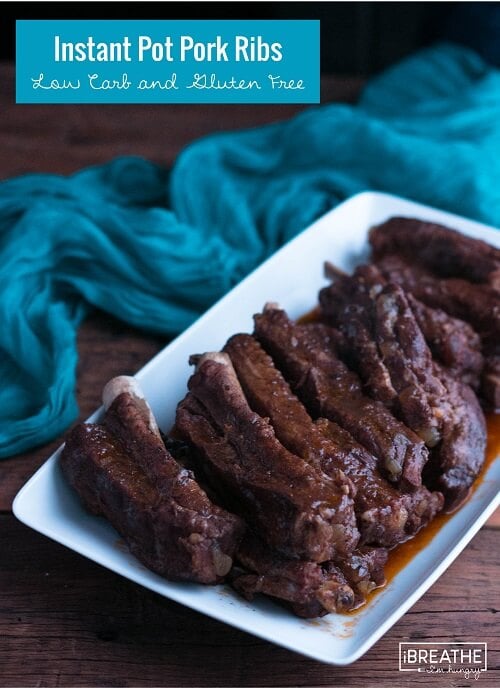 Instant pot pork ribs shown on a white platter after being sauced