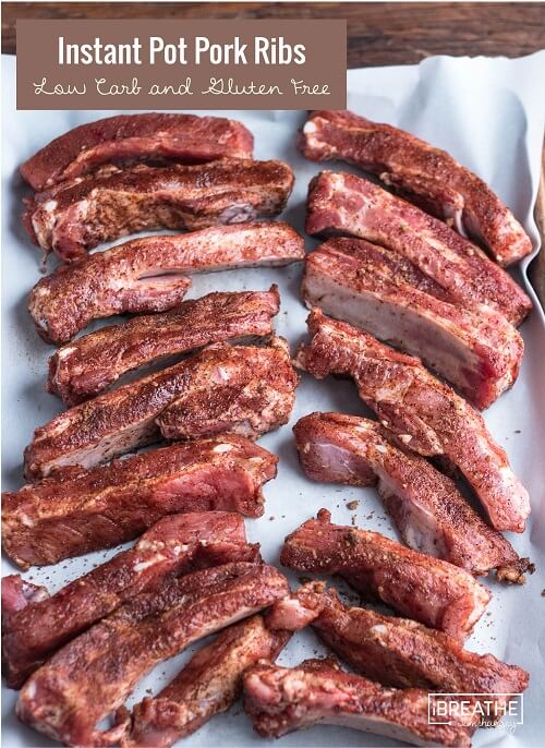 Seasoned rib sections on white parchment before cooking