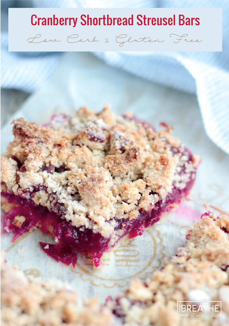 Gooey cranberry filling oozing out of the sides of the keto cranberry bars
