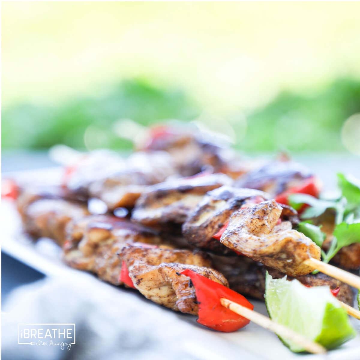 5 spice chicken skewers with red peppers and lime.