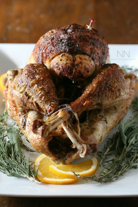 Keto Roasted Turkey on a white platter with rosemary