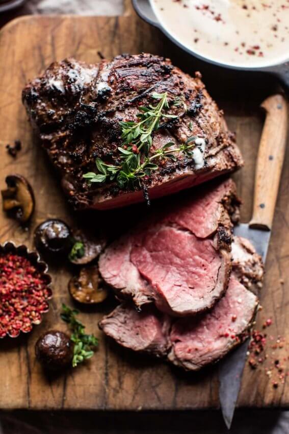 Roasted Beef Tenderloin sliced on wooden cutting board