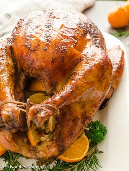 Roasted turkey with oranges on platter