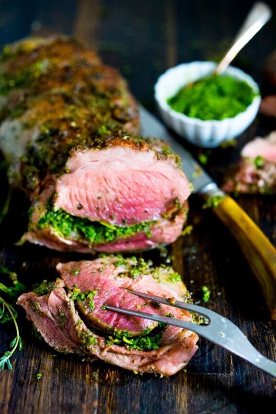 Herb Crusted Leg of Lamb sliced with green sauce