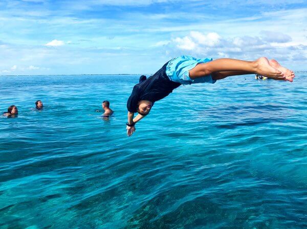 Child diving into the ocean