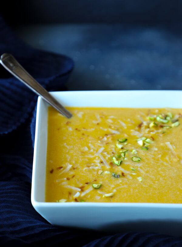 Keto curried squash soup in a square white bowl
