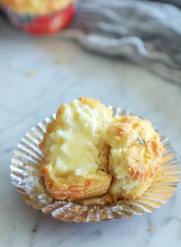 Keto Cheesy Herb Muffin cut in half and slathered in butter