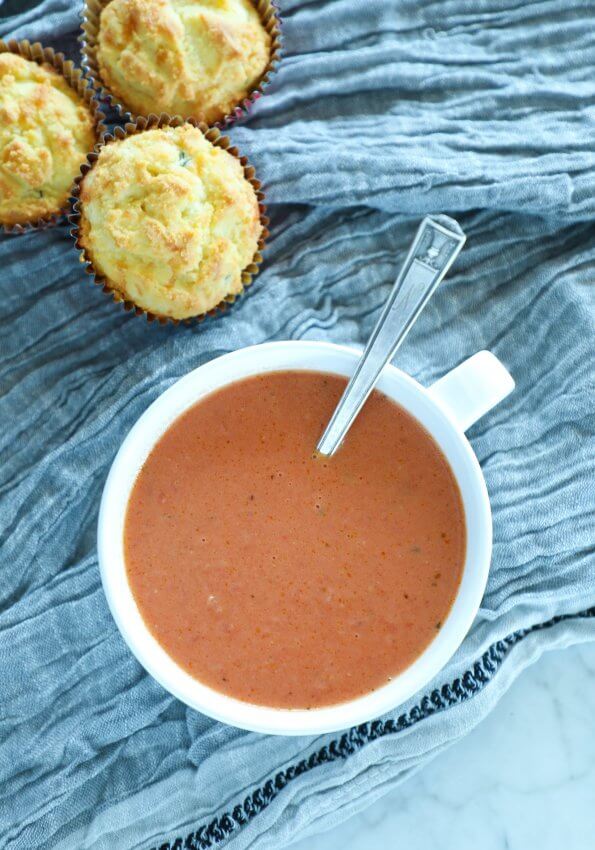 Easy Keto Tomato Basil Soup in a white bowl with spoon