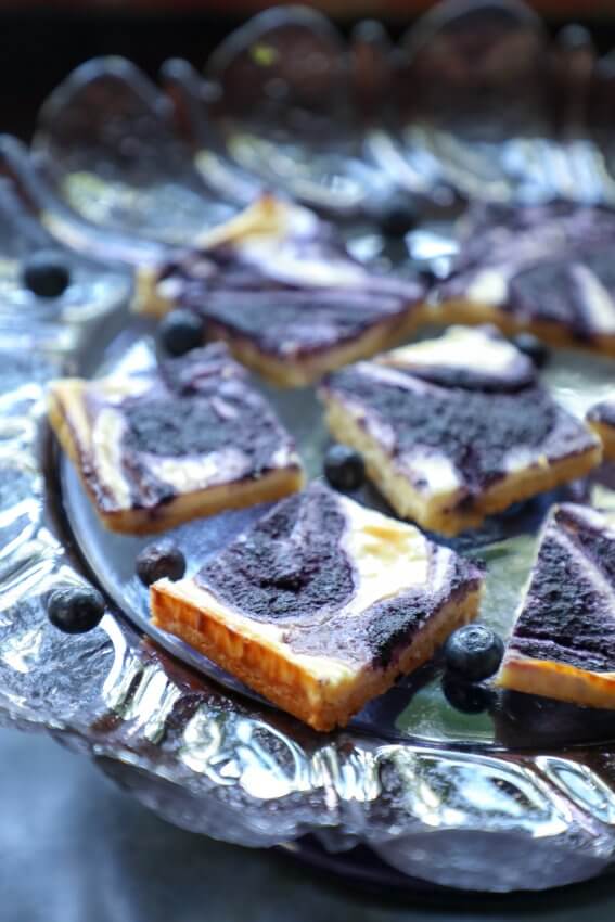 Easy Keto Blueberry Cheesecake Bars on purple cake plate