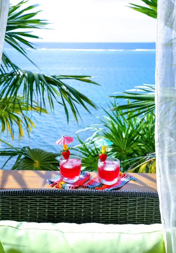Easy Keto Rum Punch with palm trees and ocean view