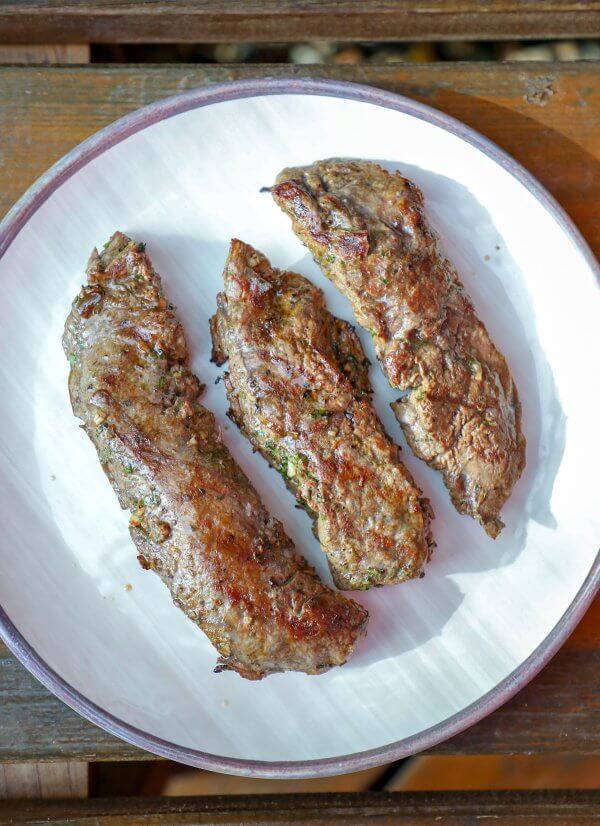 Keto Carne Asada grilled and ready for slicing on a white plate