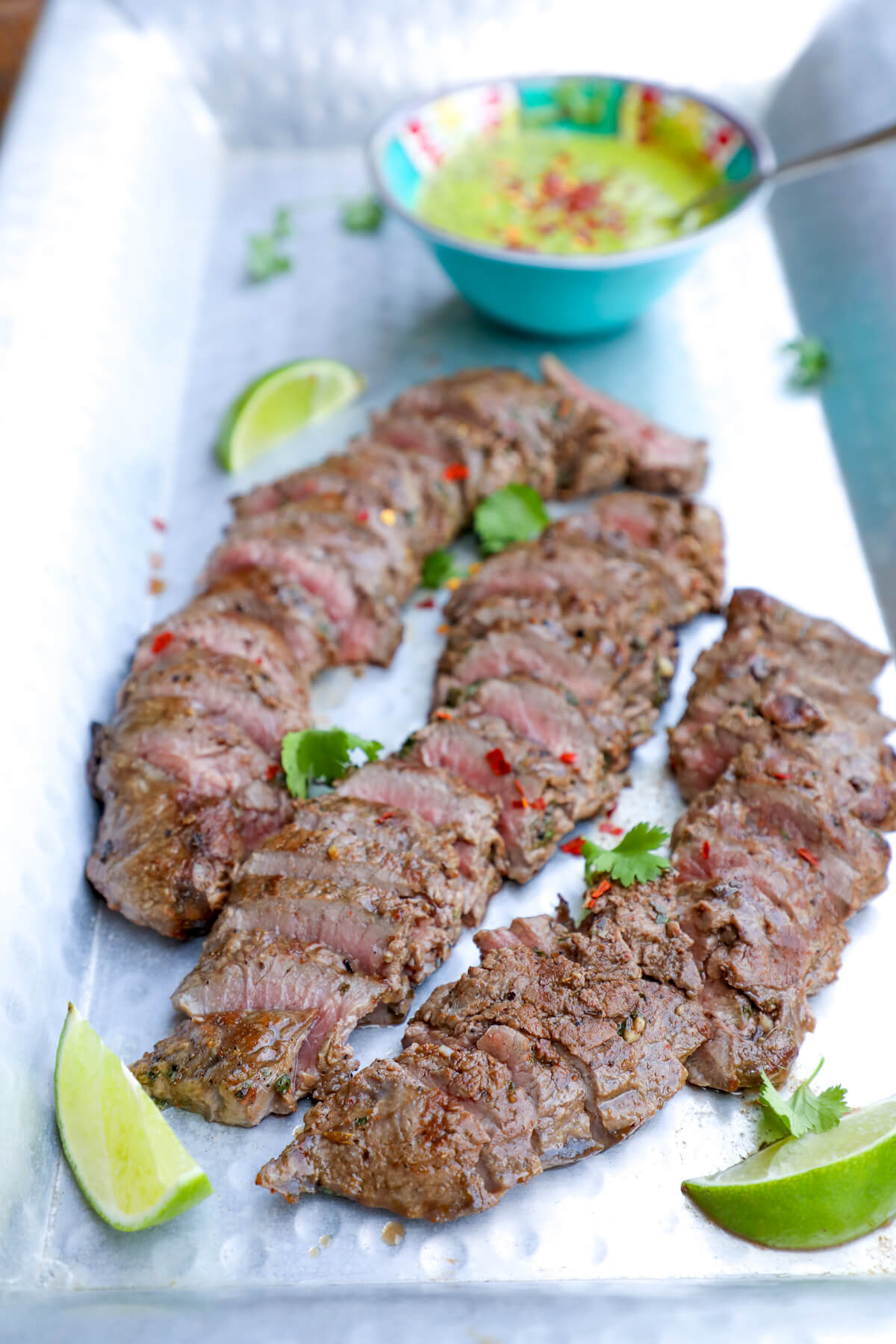 Keto Carne Asada with Chimichurri on a sliver platter