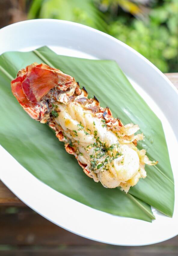 Keto Grilled Lobster Tails with Creole Butter on banana leaf