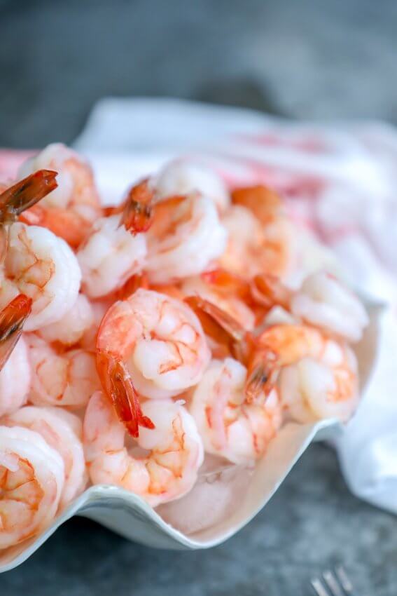 keto shrimp cocktail with 3 sauces in a shell bowl