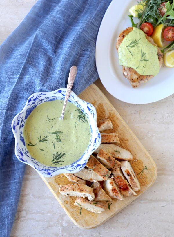 Keto Chicken & Creamy Dill Sauce on a wooden cutting board