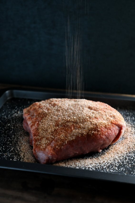 Keto Beef Brisket in the Instant Pot with seasoning raining down from above