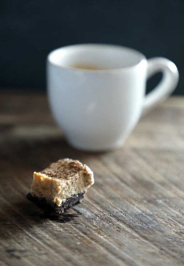 keto espresso chocolate cheesecake bars with espresso cup in background