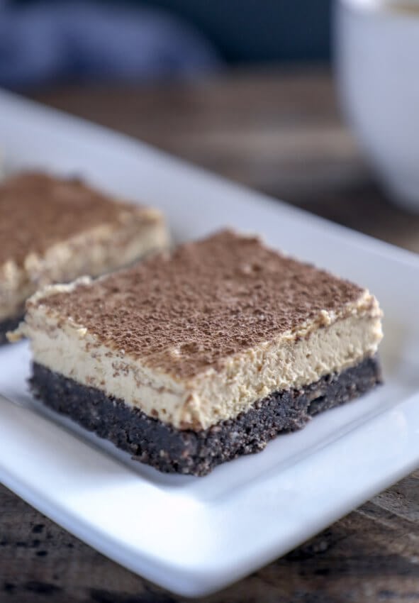 keto espresso chocolate cheesecake bars on white rectangular plate