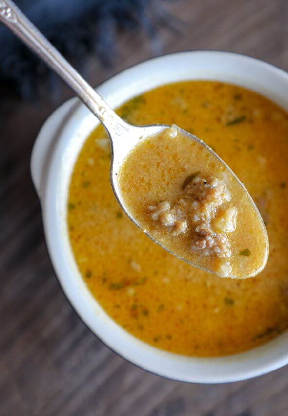 Creamy Keto Pumpkin & Sausage Chowder on a spoon from above