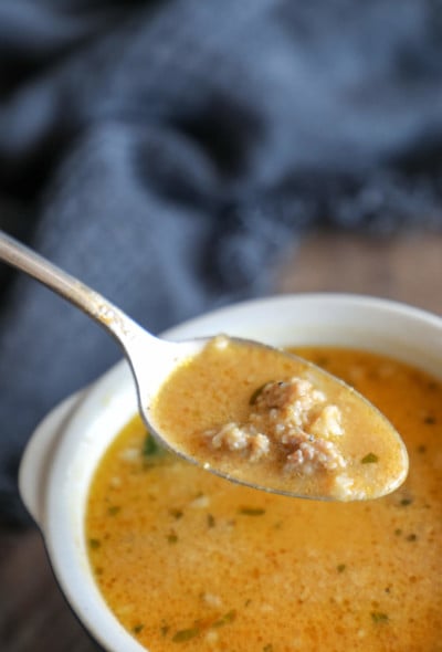 Creamy Keto Pumpkin & Sausage Chowder front view on a silver spoon