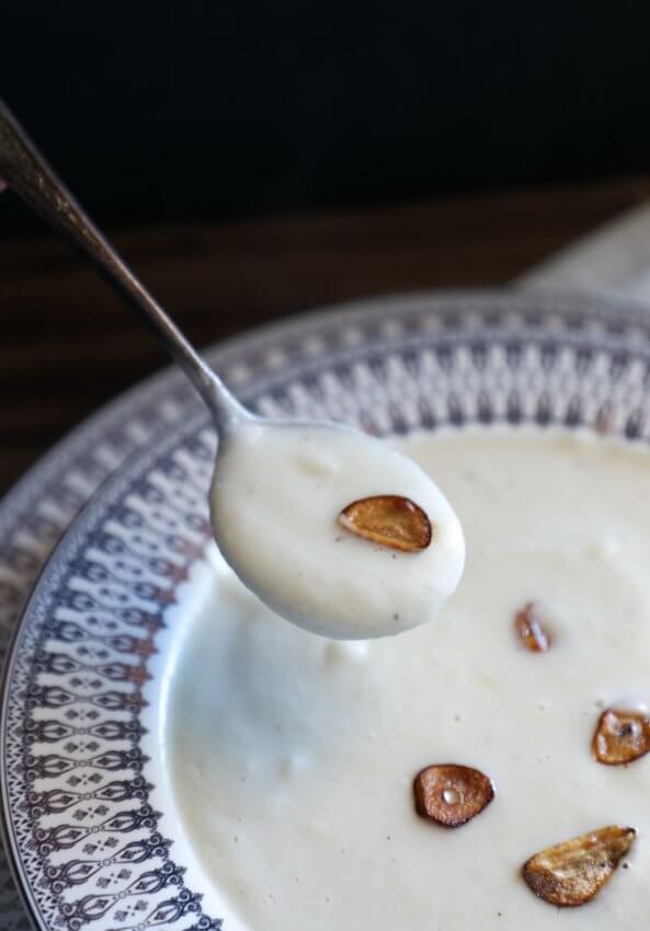 Instant Pot Keto Cheesy Cauliflower Soup on a soup spoon