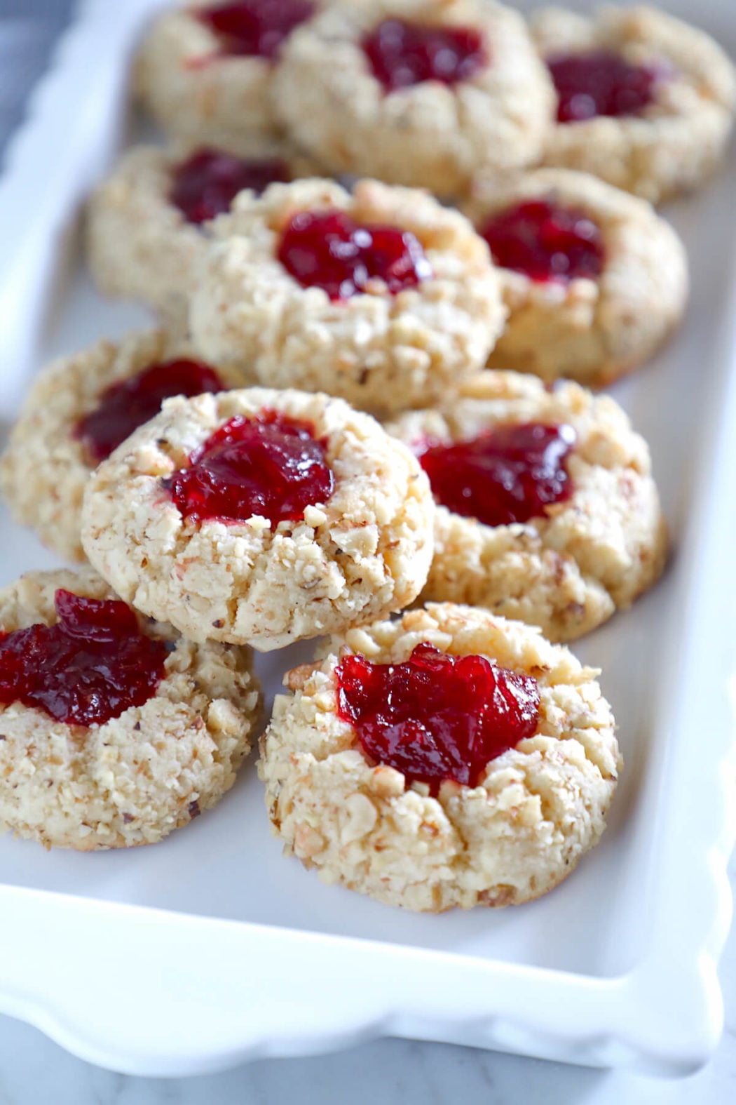 keto thumbprint cookies on a rectangular white plate
