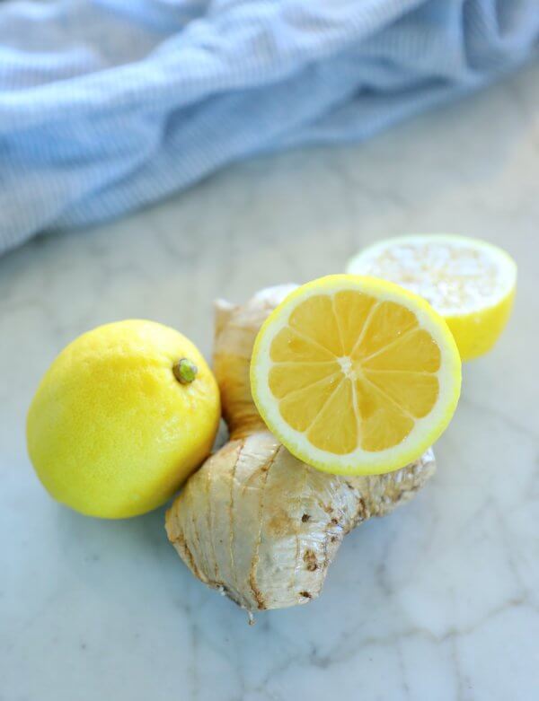 keto ginger lemon detox drink - lemons and ginger on a marble board