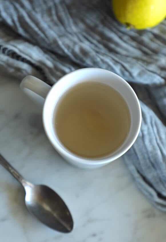 keto ginger lemon detox drink in a white tea cup hot