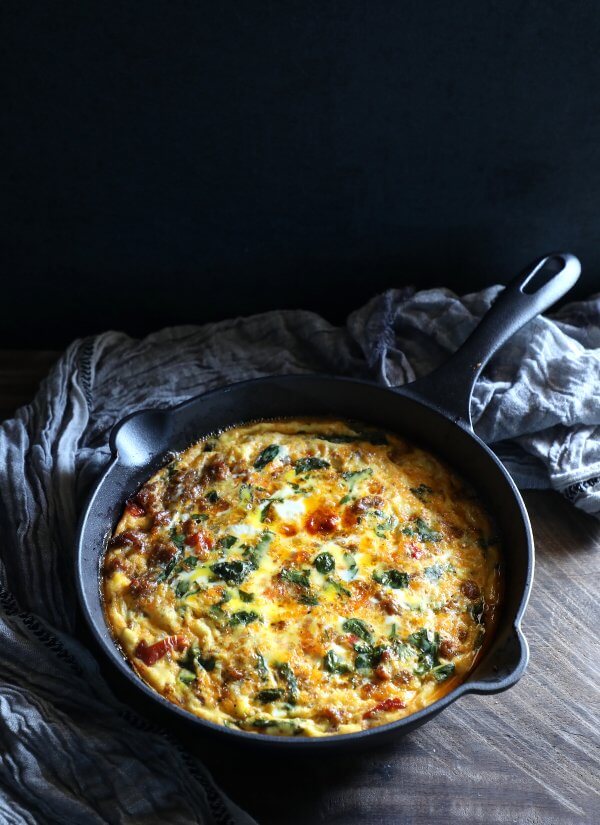 Keto sausage frittata SCKC with a black background and grey linens
