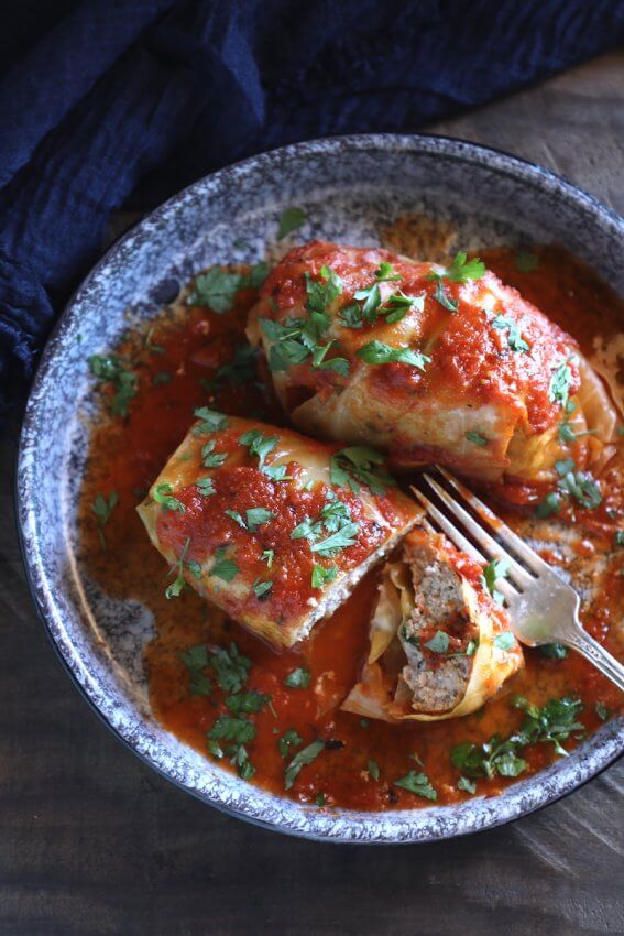keto stuffed cabbage in the instant pot on a blue plate with a fork