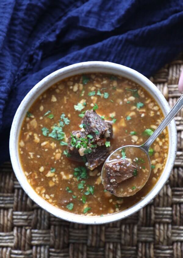 Instant Pot Keto Beef Barley Soup with a spoon from above