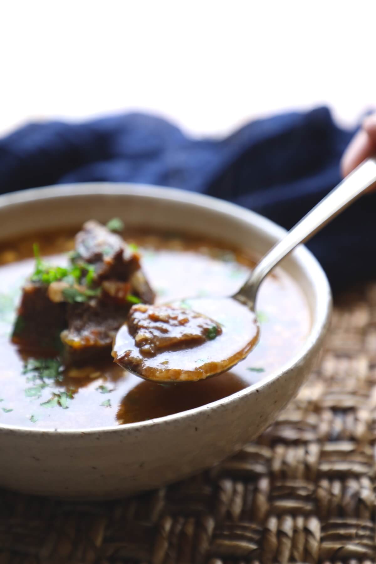 Instant Pot Keto Beef Barley Soup in a pottery bowl