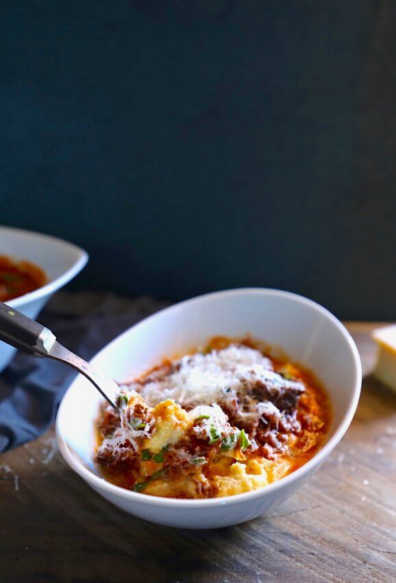 Keto Short Rib Ragu served over cauliflower polenta with a forkful.